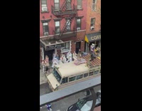 Women in gown dance outside funeral homes