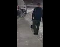 Dad shows off electric shovel in snow covered front yard 
