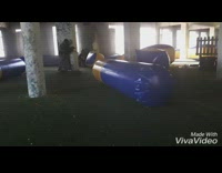 Guy walks into the open around paintball arena and shoots friend in the back on the ground