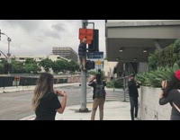 Barefoot guy climbs metal stoplight pole 