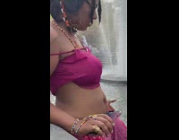 Guy walking in the water fountain with his pants rolled up 
