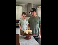 Little boy falls off chair high five cake 