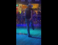 Man in white cowboy hat on the dance floor and filmed