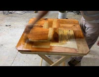 Time lapse man paint varnish on table