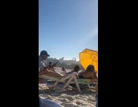 Girl butt swimsuit beach bed yellow umbrella