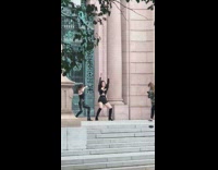 Two girls black clothes dance green gate