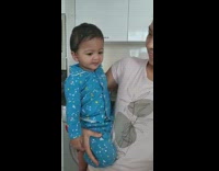 Lady Feeds Baby as She Holds Him