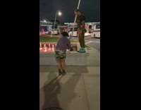 Guy green shoes walk on fountain ledge