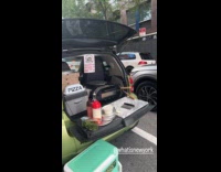 Electric car parked on street sells pizza