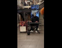 Michael Myers playing horror music at train station 