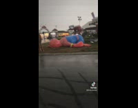 Spiderman balloon deflated face down on floor grass 