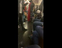 Guy on subway wears long red cape 