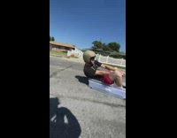 Guys in plastic container get towed by car 