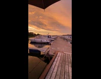 Sunrise rain and rainbow at boat docks