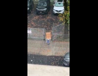 Person use plastic and box as rain cover