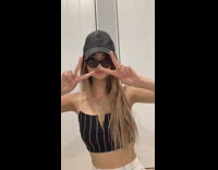 Girl puts on sunglasses by turning head, flips hat from mouth onto head