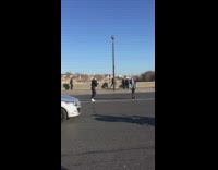Woman in striped jacket poses in the middle of the road 