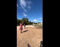 Woman points up pose front of pyramid