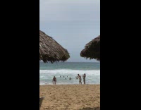 Man blue shorts did a backflip at the beach shore