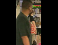 Guy carries hot pink dance pole box