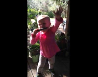 Little girl calls dog by playing harmonica