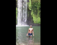 Guy shorts eyes closed palms open waterfalls