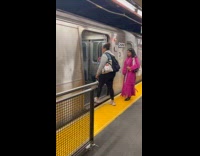 Man riding motorcycle into subway train
