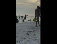 Woman with hat lay on beach sunset