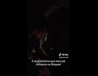 Man demonstrates flashlight bought from Shopee 