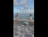 Woman removes white shirt towards the beach