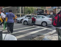 Group of people help driver who got his car stuck on curb 