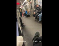 Man plays the trumpet inside subway train
