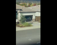 Grey car in garage sideways trying to get out 