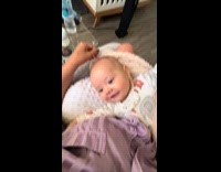 Mother rubs head of his newborn son