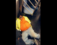 Drunk man sleeps on the floor wearing glasses with eyes printed on them