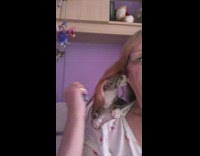 Pet kitten on owners shoulder and sucks earlobe