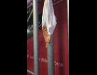 Pizza hung by white boxer underwear in subway station