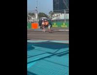 Woman in crop top poses on the race track