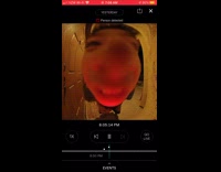 Boy eats strawberry by security camera house 