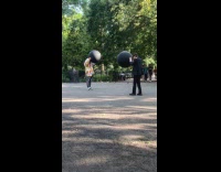 Collab WINY - Men with giant black balloons bumps each other