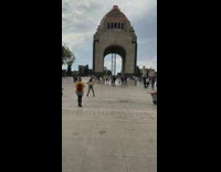 Girl dances in front of temple arch Mexico City