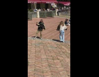 Woman poses while a man holds the phone in selfie mode