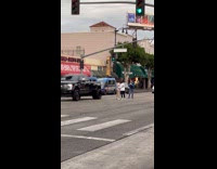 Two women poses middle of the street