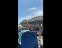 Woman orange hair bikini shake butt beach