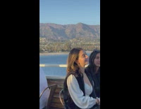 Woman fixes her jacket reveal cleavage photo shoot