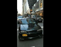 Man Opens Car Door as he Waits for Stoplight