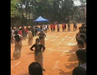 Black shirt girl falls potato sack race