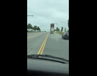 Dump truck with bed up crashes into traffic light pole 