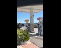 Woman crop top poses at gas station