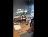 Man drive and crash car into dealership